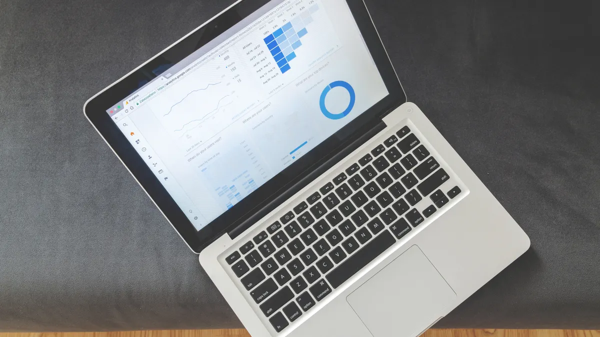 Laptop displaying analytics dashboard charts