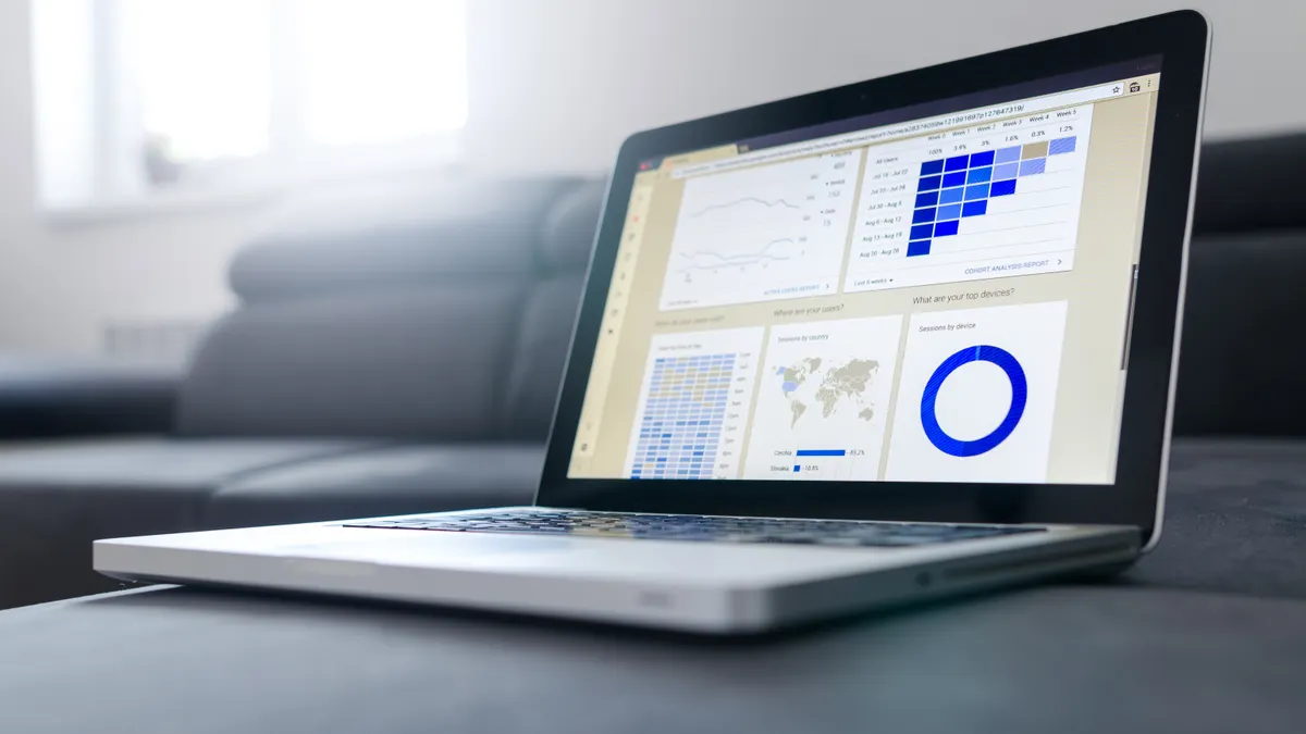 Laptop displaying analytics dashboard charts